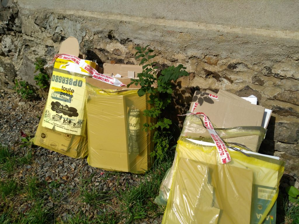 Gele vuilniszakken met stickers die aangeven dat afval niet goed is aangeboden.